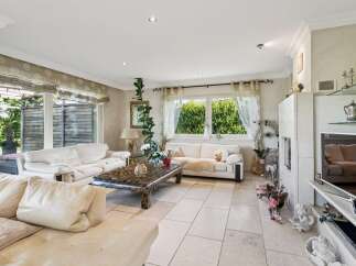 Step into this elegant living room, featuring plush white sofas perfect for relaxation and entertaining.