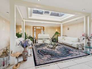 Step into this elegant living room, bathed in natural light from a stunning skylight.