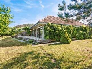 Enjoy outdoor living with this charming property featuring a spacious wooden deck perfect for entertaining or relaxing.
