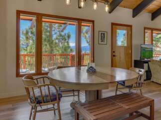 Enjoy breathtaking mountain and lake views from this charming dining area, perfect for family gatherings.