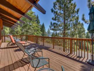 Enjoy breathtaking lake and mountain views from this expansive wooden deck, perfect for outdoor entertaining or quiet relaxation.