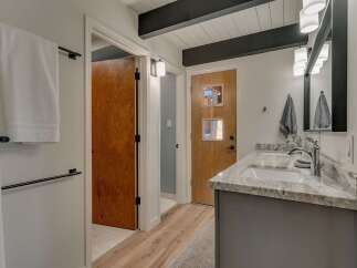 Experience modern comfort in this beautifully appointed bathroom, featuring a sleek double vanity with granite countertops and contemporary fixtures.