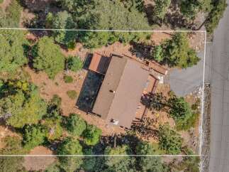 Discover this charming home nestled amidst mature trees, offering a serene and private retreat.