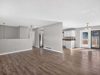 Discover this charming home featuring an open-concept living space with a modern kitchen and a spacious dining area.