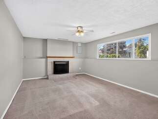 Cozy up by the fireplace in this inviting living space, perfect for relaxation and gatherings.