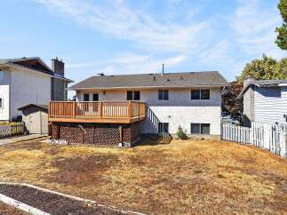 Enjoy outdoor living with this spacious wooden deck, perfect for entertaining or relaxing.