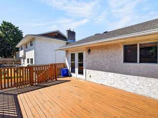 Enjoy outdoor living on this spacious wooden deck, perfect for entertaining or relaxing.