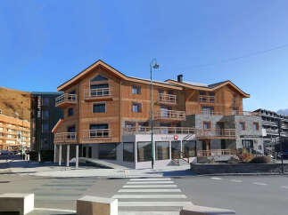 Discover this stunning multi-story wooden building with stone accents, featuring numerous balconies and large windows.