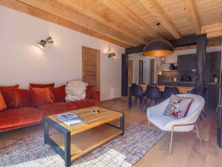 Experience modern alpine living in this beautifully appointed living space, featuring a plush velvet sofa and a stylish coffee table perfect for relaxation.