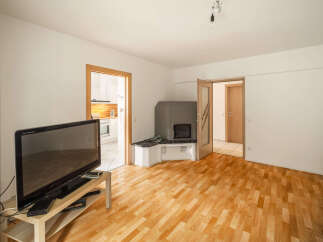 This spacious living room features a modern fireplace and a large flat-screen TV, perfect for cozy evenings.