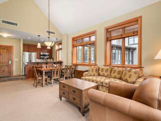Experience comfortable living in this spacious open-concept condo, featuring a modern kitchen with stainless steel appliances and rich wood cabinetry.