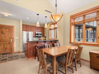 This inviting dining area features a warm wooden dining table with six chairs, perfect for family meals or entertaining guests.