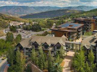 Experience luxury mountain living in this stunning property, featuring modern architecture with expansive windows and private balconies.