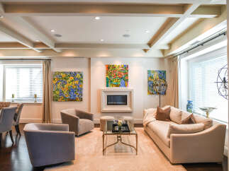 Experience luxurious living in this elegantly appointed living room, featuring a modern fireplace and plush seating arrangements.