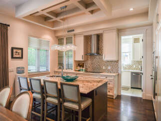 Experience luxury in this stunning kitchen featuring a grand granite island with a waterfall edge, perfect for entertaining.