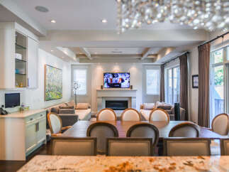 This spacious living and dining area features a modern fireplace and a large flat-screen TV, perfect for entertaining.