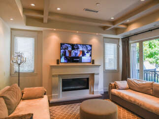 Experience modern living in this beautifully appointed living room, featuring a sleek fireplace and a large flat-screen TV perfect for entertainment.
