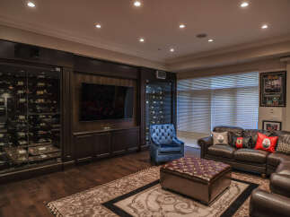 Experience ultimate relaxation in this luxurious man cave, featuring a state-of-the-art wine cellar with climate-controlled storage for your prized collection.
