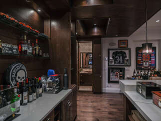 Step into this sophisticated home bar, perfect for entertaining guests.