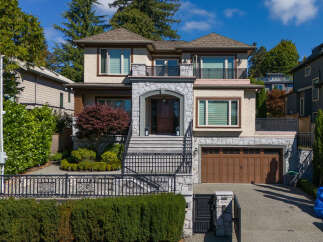 This stunning two-story home boasts a charming stone facade and a welcoming covered entryway with a grand wooden door.