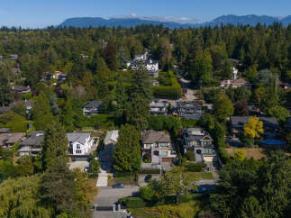 Discover luxurious living in this stunning multi-level home, nestled amidst lush greenery and mature trees.