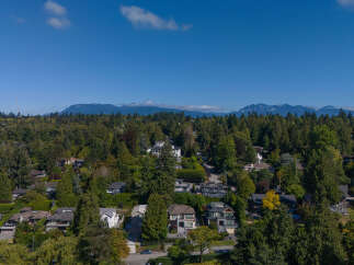 Nestled amidst lush greenery and mature trees, this stunning property offers a serene escape with breathtaking mountain views.