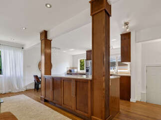 Discover an open-concept living space seamlessly connecting to a modern kitchen, perfect for entertaining.