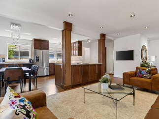 This spacious open-concept living area seamlessly blends a modern kitchen with a comfortable living room.
