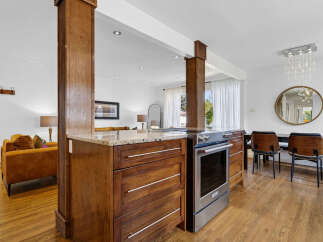 Experience seamless living in this open-concept home, featuring a modern kitchen with rich wood cabinetry and granite countertops, perfect for culinary enthusiasts.