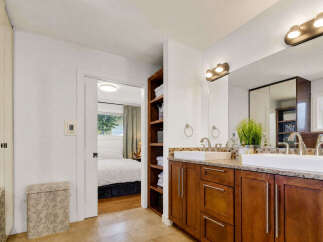 This spacious bathroom features a double vanity with modern fixtures and ample counter space, perfect for busy mornings.