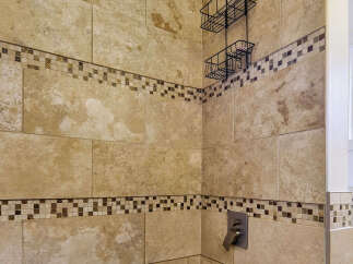 Experience luxury in this modern bathroom featuring a spacious bathtub and a sleek rainfall showerhead.