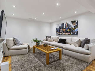 Experience ultimate relaxation in this modern living room, featuring a plush sectional sofa perfect for movie nights and a stylish coffee table.