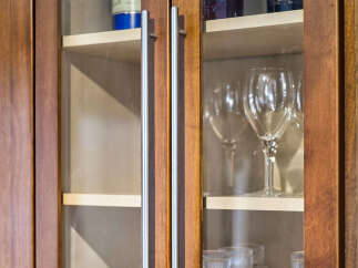 Showcase your favorite spirits and glassware in these elegant glass-fronted kitchen cabinets.