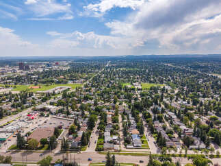 Discover this charming suburban neighborhood from a bird's-eye view, showcasing a mix of well-maintained homes nestled among mature trees.