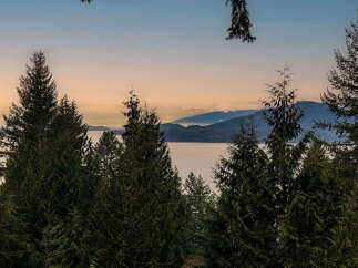 Experience breathtaking panoramic views of the serene ocean and majestic mountains from this stunning property.