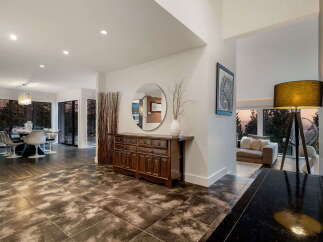 Step into this stunning modern home featuring an open-concept living and dining area with large windows offering breathtaking views.
