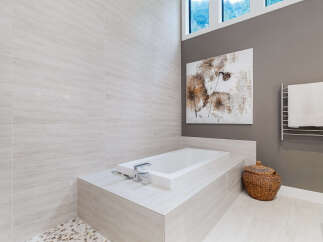 Experience luxury in this modern bathroom featuring a deep soaking tub, perfect for unwinding.