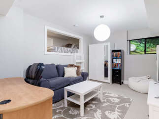 Discover this versatile living space featuring a cozy built-in loft bed, perfect for guests or a creative nook.