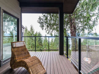 Enjoy breathtaking water and forest views from this stunning balcony, perfect for relaxation and entertaining.