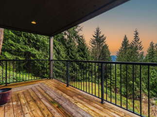 Enjoy breathtaking views from this spacious wooden deck, perfect for outdoor entertaining or quiet relaxation.