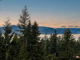 Experience breathtaking panoramic views of the ocean and majestic mountains from this stunning property.