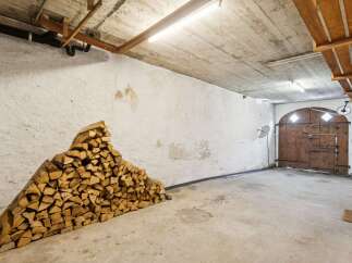 Discover this spacious garage with ample storage, perfect for vehicles or as a workshop.