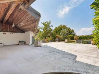 Discover this charming outdoor space featuring a spacious paved patio perfect for entertaining or relaxing.