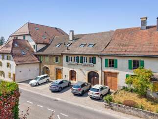 Discover this charming property featuring a classic European architectural style with a terracotta tile roof and traditional green shutters.