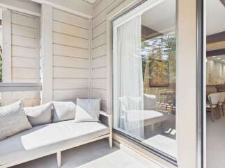 Enjoy outdoor living on this charming balcony, perfect for relaxing with a book or enjoying your morning coffee.