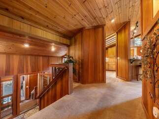 Step into a warm and inviting home with stunning wood-paneled walls and ceilings throughout.