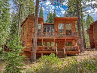 Nestled amidst towering pine trees, this stunning multi-level wooden home offers a serene mountain retreat.