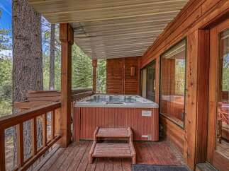 Relax and unwind in this charming cabin getaway, featuring a private hot tub perfect for soaking in the serene forest surroundings.