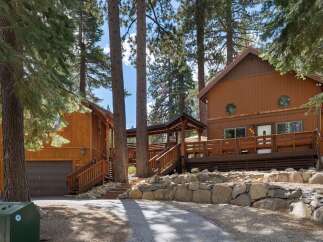 Nestled amongst tall pine trees, this charming wooden home offers a serene mountain retreat.