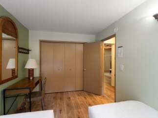 This charming room features a convenient desk area with a mirror and a lamp, perfect for getting ready or catching up on work.